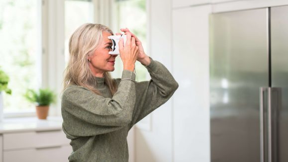 Lady uses a tonometer at home