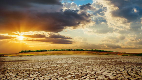 drought earth in sunset. dramatic sky over desert. change climate