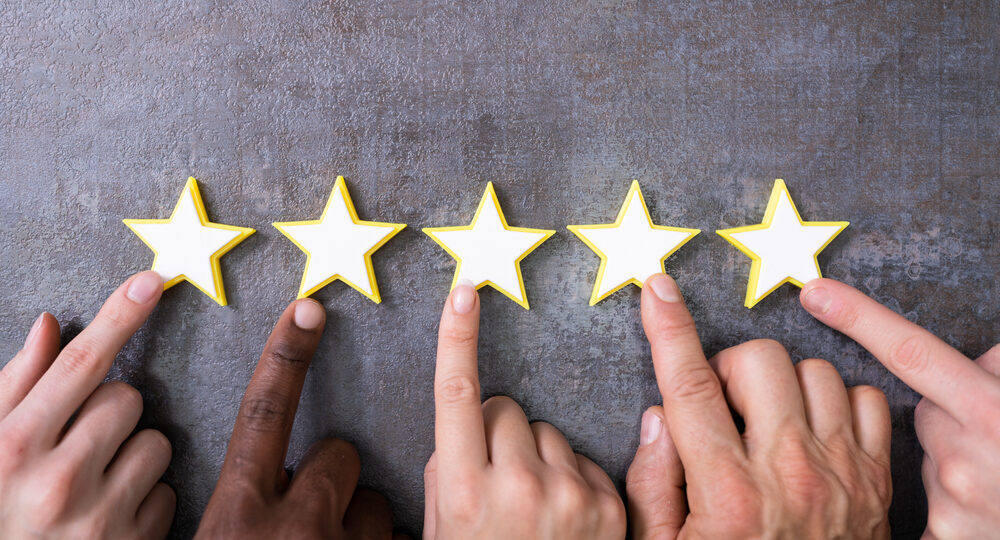 Person,Hands,Aligning,Five,Star,Rating,Icons.,High,Angle,View