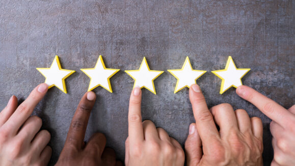 Person,Hands,Aligning,Five,Star,Rating,Icons.,High,Angle,View