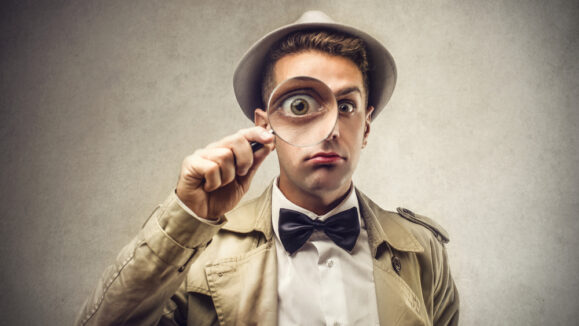 Investigator,Looking,With,Magnifying,Glass