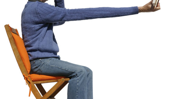 Short,Sighted,Man,Needs,Binoculars,To,Read,His,Book