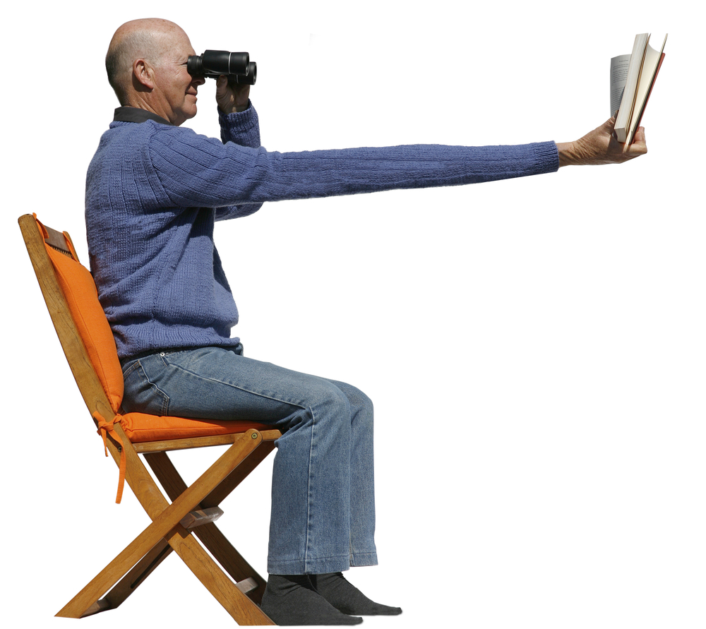 Short,Sighted,Man,Needs,Binoculars,To,Read,His,Book