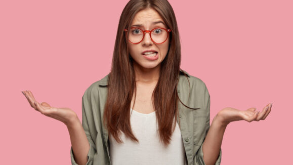 Indifferent,Puzzled,Female,Shruggs,Shoulders,,Purses,Lips,,Has,Clueless,Expression,