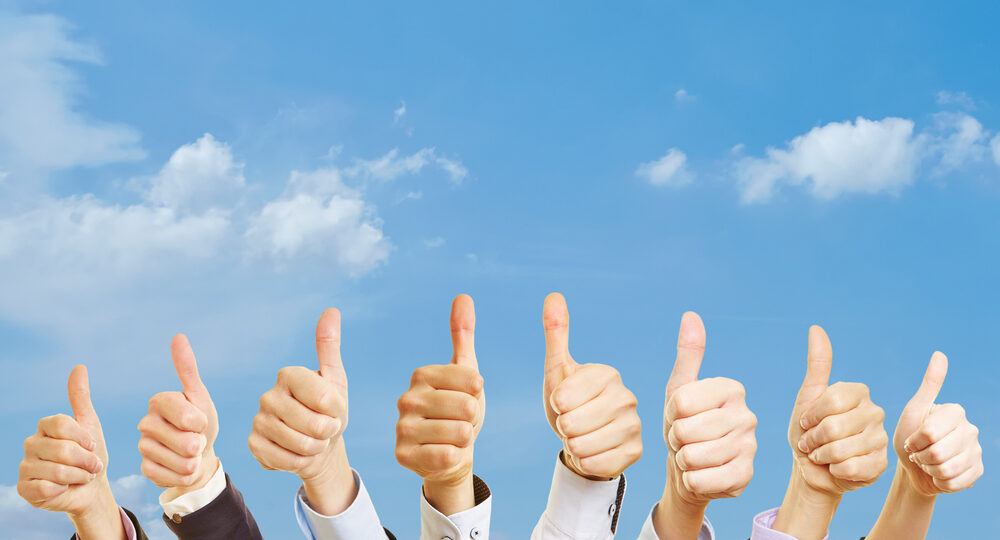 Business,Team,Under,The,Sky,With,Thumbs,Up